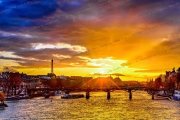 Radiant sunset over the Seine River with the Eiffel Tower and bridges of Paris