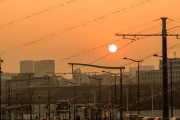 Sunset view over a tram line with cityscape and traffic