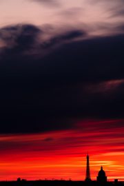 Crimson Cloak: Parisian Landmarks at Sunset