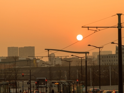 Sunset view over a tram line with cityscape and traffic